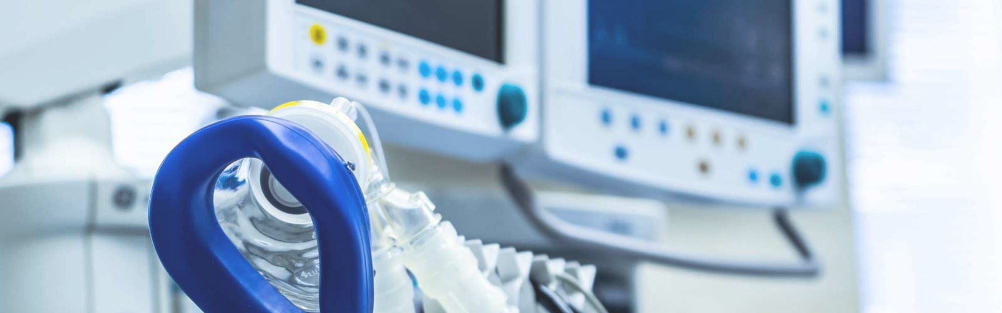 Medical oxygen mask with medical screens in the background